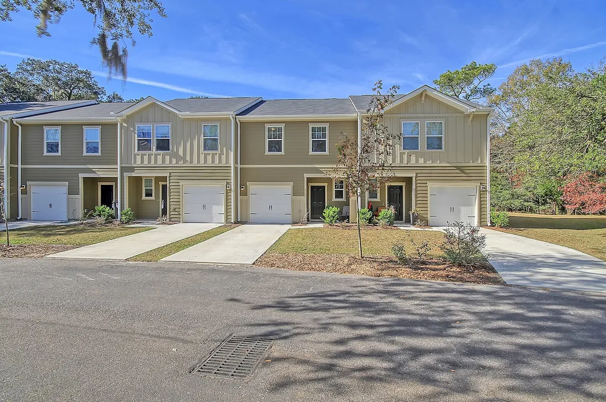 A row of inviting townhouse structures stands amid well-tended landscaping and private driveways. The scene suggests a welcoming, community-focused neighborhood, ideal for family activities and social gatherings. The soft evening light and visible pathways invite exploration and return, reinforcing a sense of belonging and comfort.